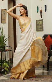 Stone White Linen Saree with a striking Zari Border & pallu