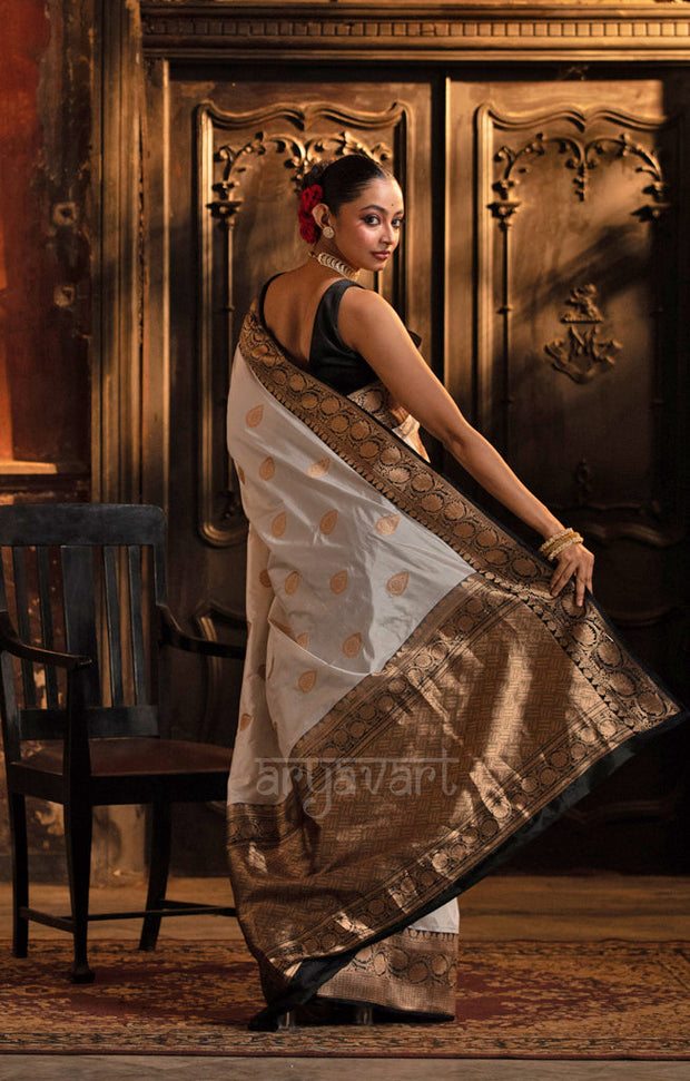 Striking White Katan Silk Saree With A Black Border & Gold Buttas