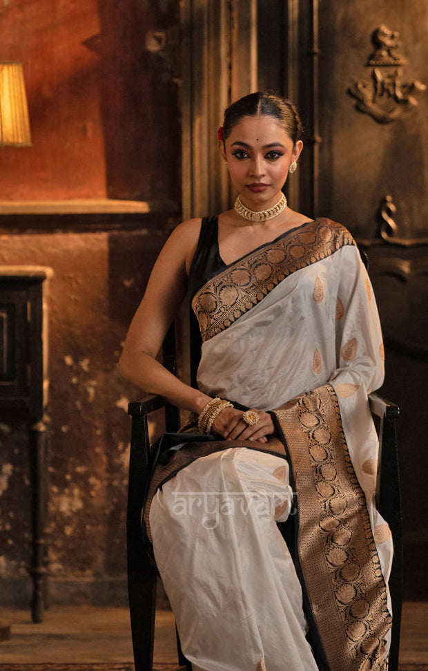 Striking White Katan Silk Saree With A Black Border & Gold Buttas